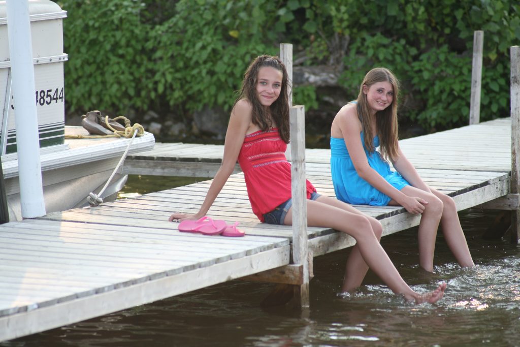 Girls enjoying sitting by the waters edge on Rice Lake