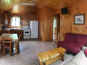 Fully equipped kitchen in a traditional cottage rental with pine accents.