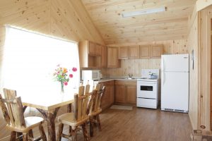 Traditional fully furnished kitchen with modern amenities in a cottage rental.