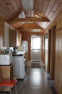 Fully equipped kitchen in a traditional cottage rental with pine accents