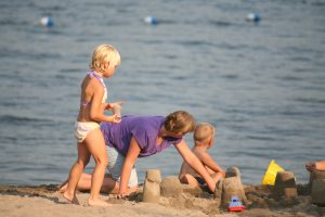 Family enjoying a sunny day on the beach at Southview Cottages, Rice Lake.