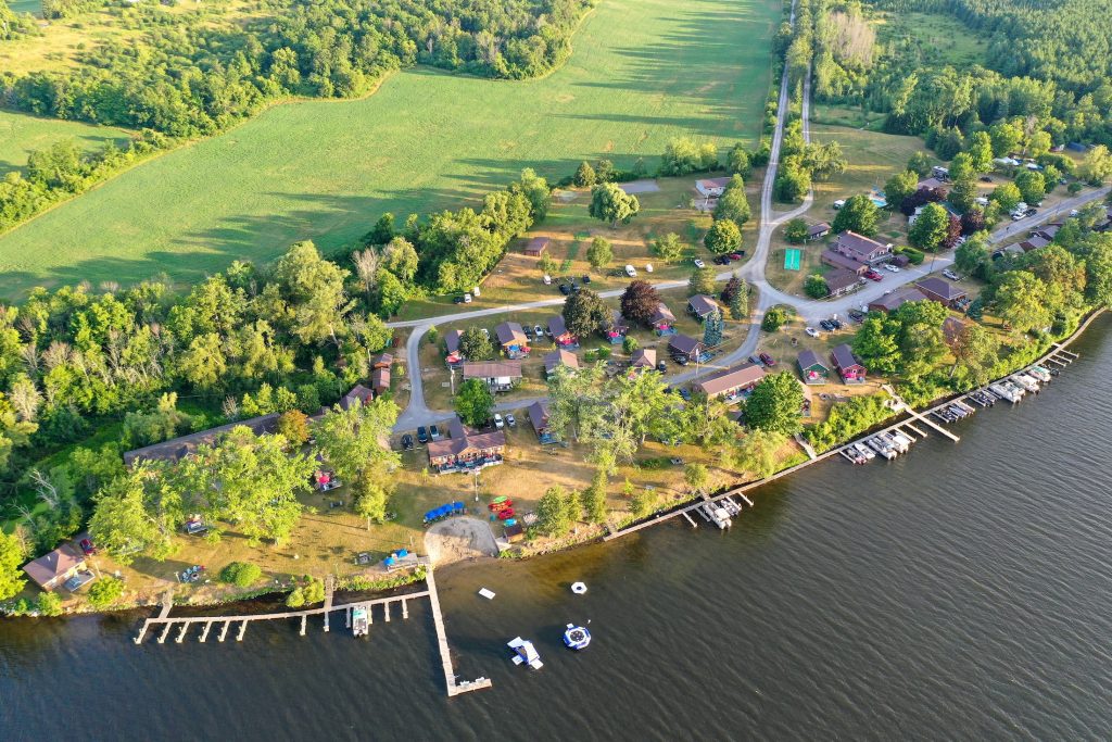 Aerial view of a cottage resort on a lake, showing docks and cabins