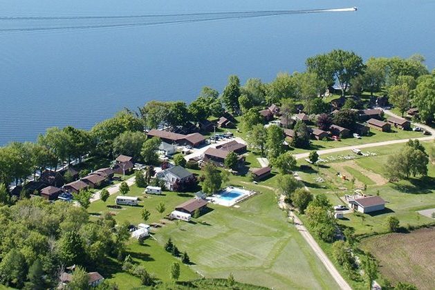 Aerial view of cottage resort, with lake and wide lawn